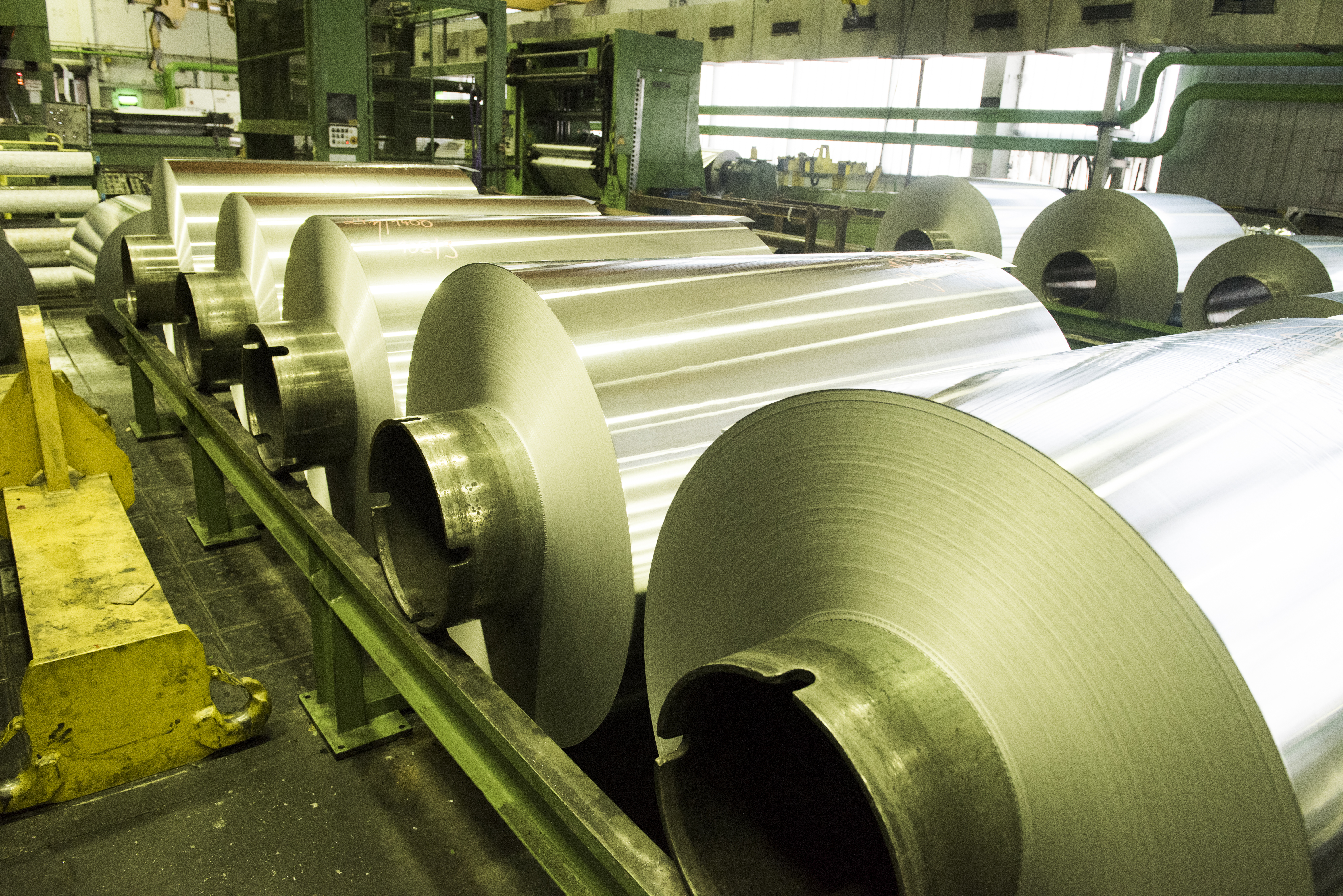 Rolled aluminium coil stock on the mill floor
